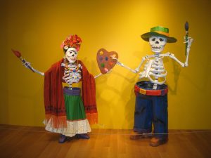 Day of the dead mannequins - a male and female skeleton who are artists