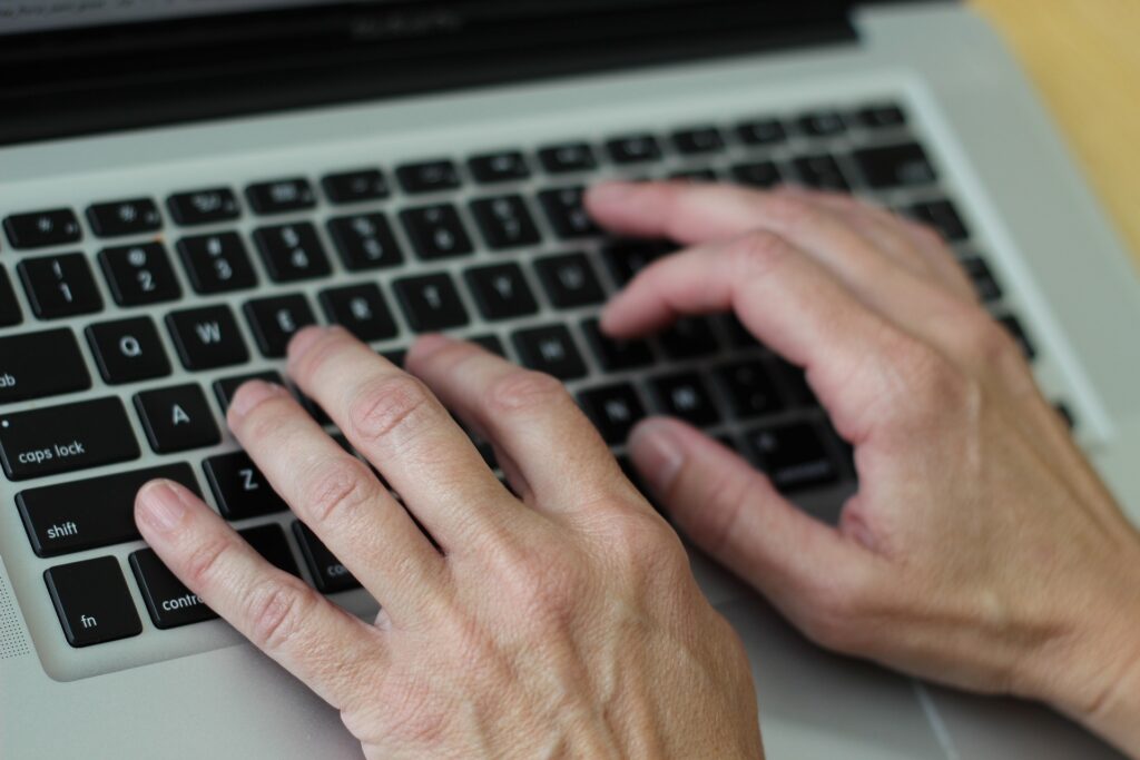 Person Typing.  Image by Victoria Loveland