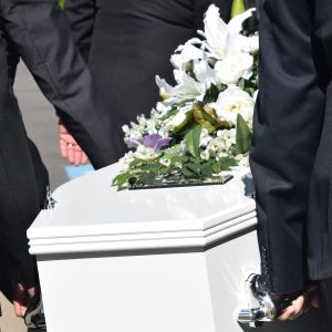 Pall bearers carrying a white casket. Learn about why funerals are important https://every1dies.org