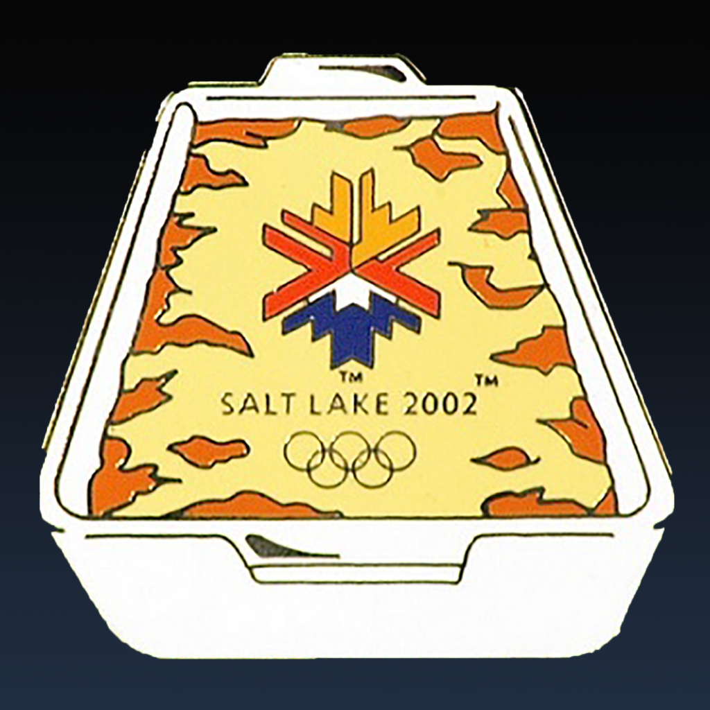 A commemorative Winter Olympics 2002 pin featuring Funeral Potatoes.