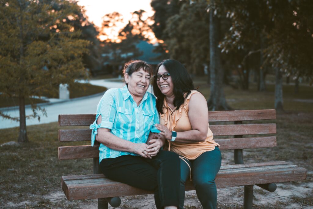 Two women friends on a park bench.