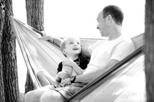 A father and son in a hammock. We learn about death of a father as well as celebrate father figures in this episode (https://every1dies.org)