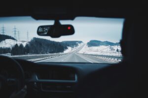 A view of a snowy road from inside a car. We talk about how to avoid a car accident in this episode.