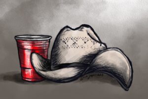 Toby Keith's straw cowboy hat next to a red solo cup.