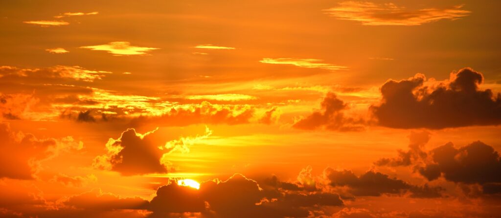 A golden sunrise filtering through clouds.