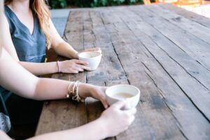 Two women talking together over coffee. We talk about how you can help a friend feel seen, heard, and understood in this episode. https://every1dies.org