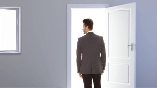 A man leaving a room through an open door. This represents the ghosting cancer patients and survivors experience by the relatives and friends they expected to support them through their journey.