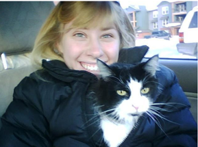 Sarah Walt Weaver and Snibbles - her sister's cat, adopted by her parents. The cat is black and white.