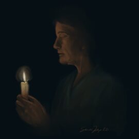 A nurse in scrubs holding a candle. We talk about honoring a nurse's life of service with the nightingale tribute or nurse honor guard in this episode.