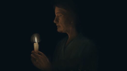 A nurse in scrubs holding a candle. We talk about honoring a nurse's life of service with the nightingale tribute or nurse honor guard in this episode.