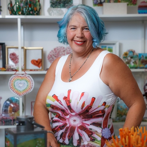 Our guest, Tabitha Burrill from Tabitha's Glass Emporium surrounded by art made with her glass.